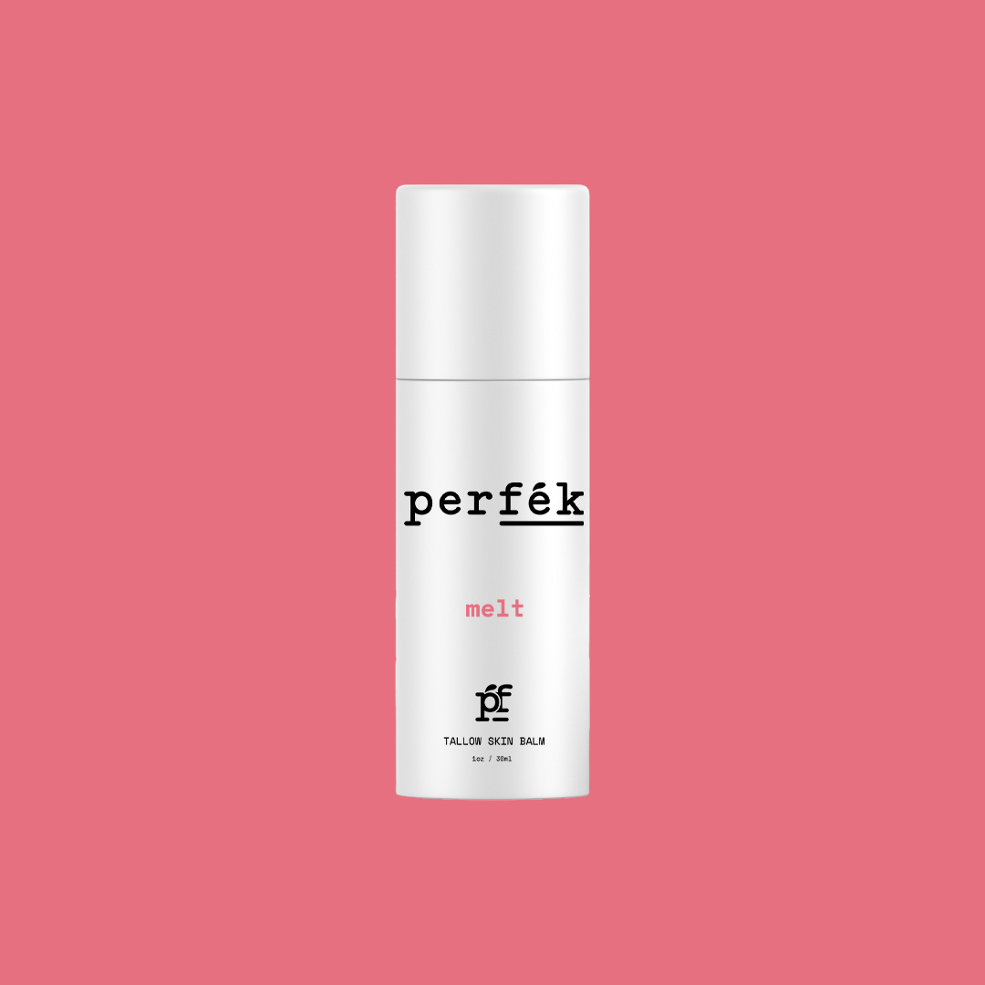 White Perfék Melt tallow skin balm tube with black and pink type on a coral pink background